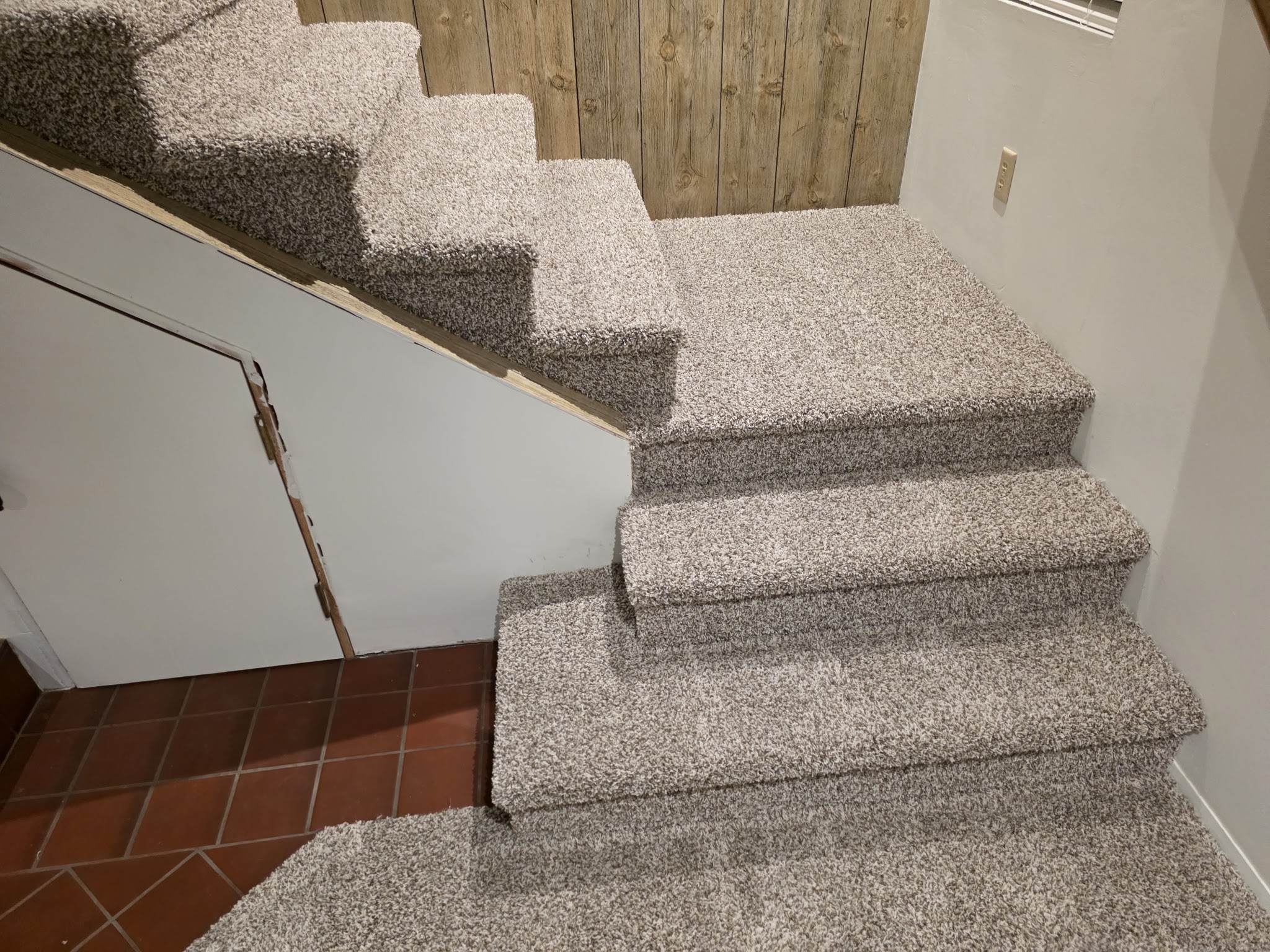 Finished carpet installation on a staircase