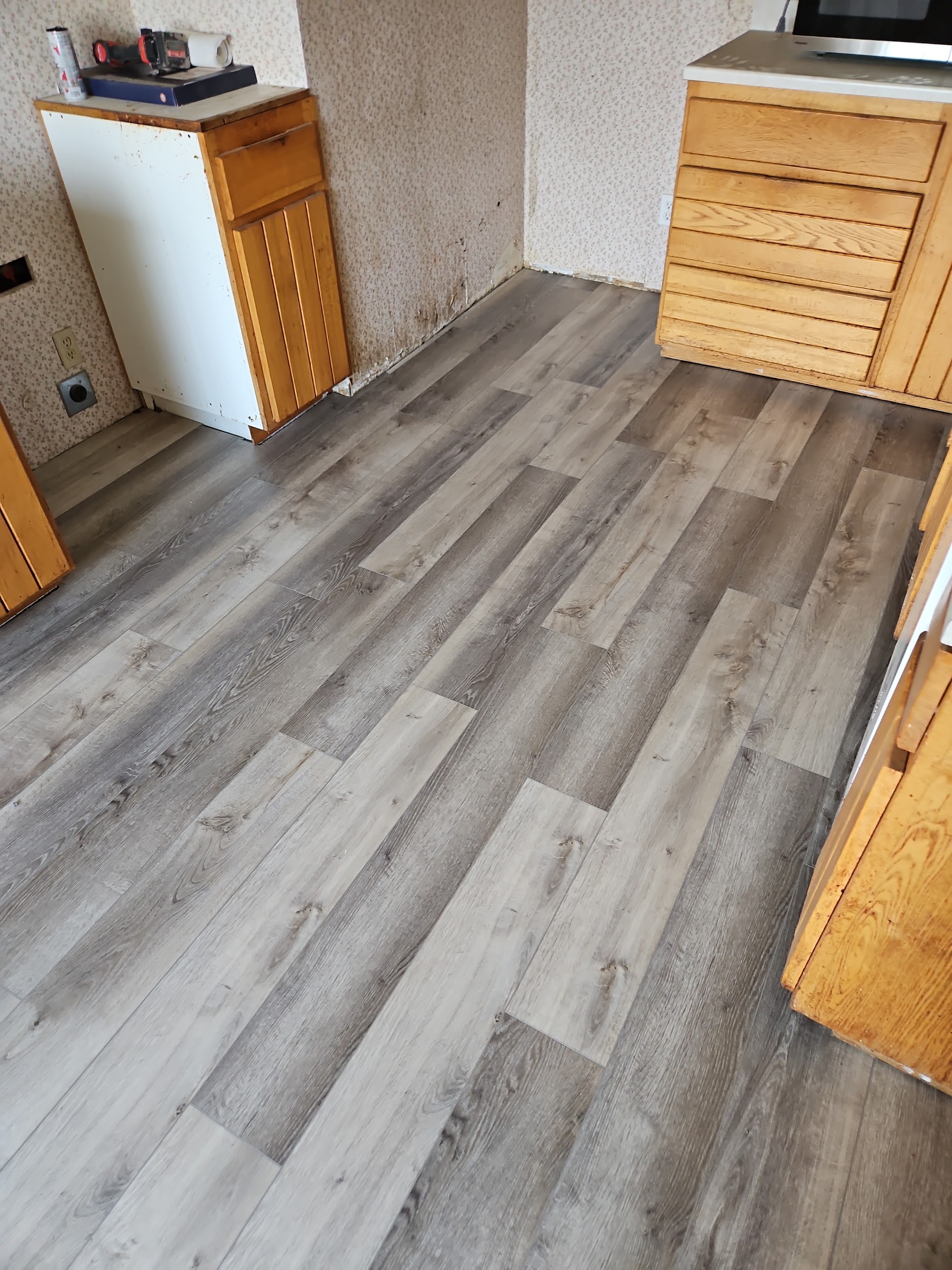Finished gray wood-look flooring installed by JV Floors in a kitchen